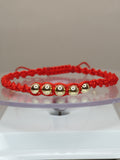 Pulsera hilo rojo estilo turbillon con balines de oro 18k ajustable hombre